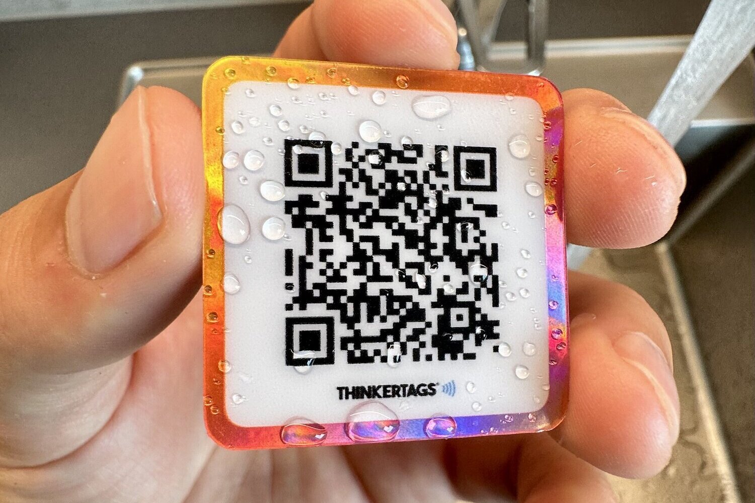 Waterproof Google review sticker held under running water